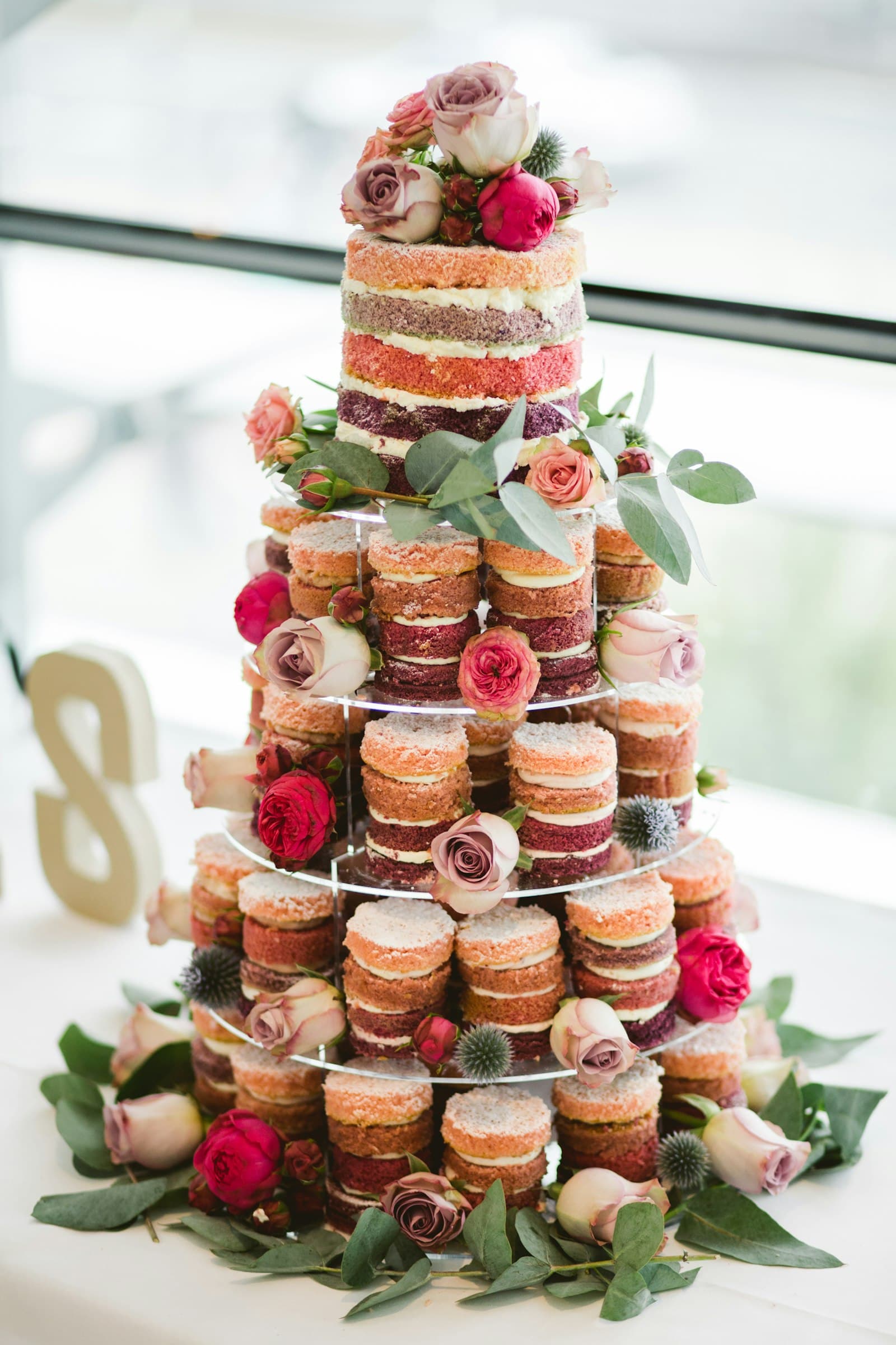 Tiered wedding cake decorated with fresh flowers