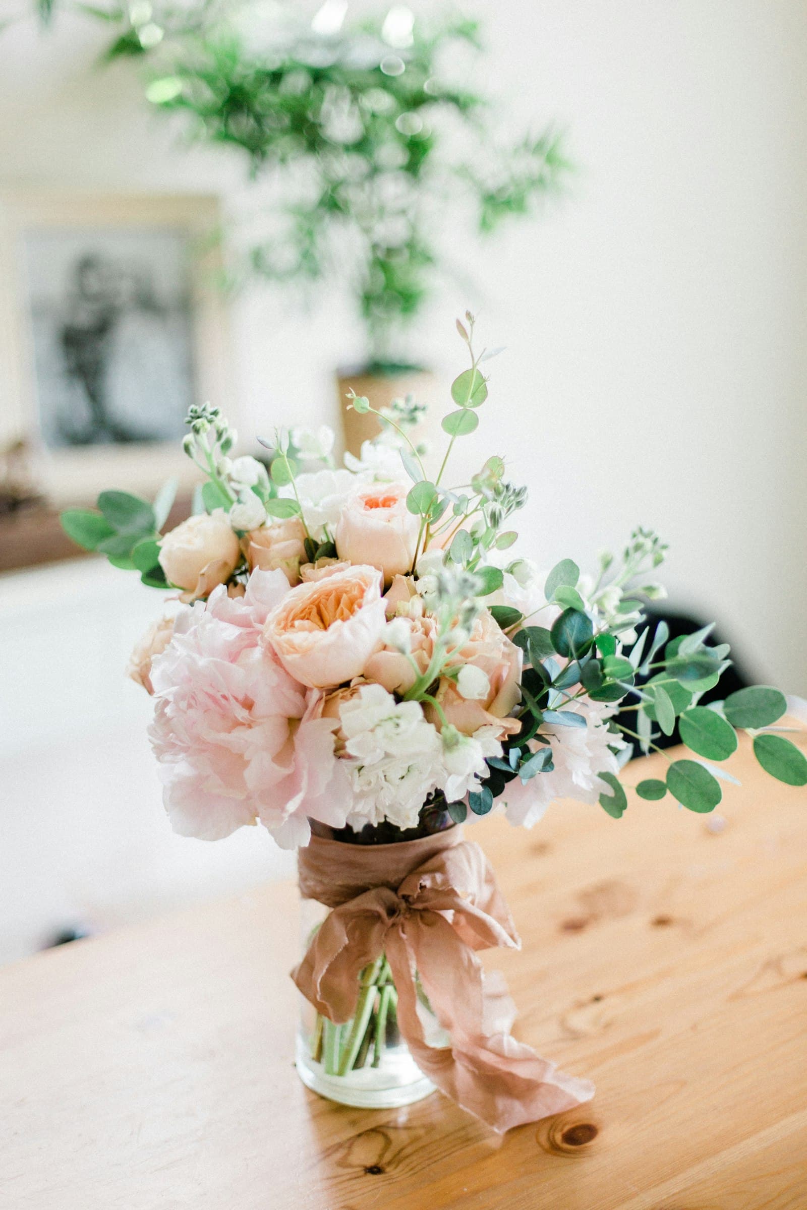 Peach garden roses and eucalyptus wrapped with a silk ribbon